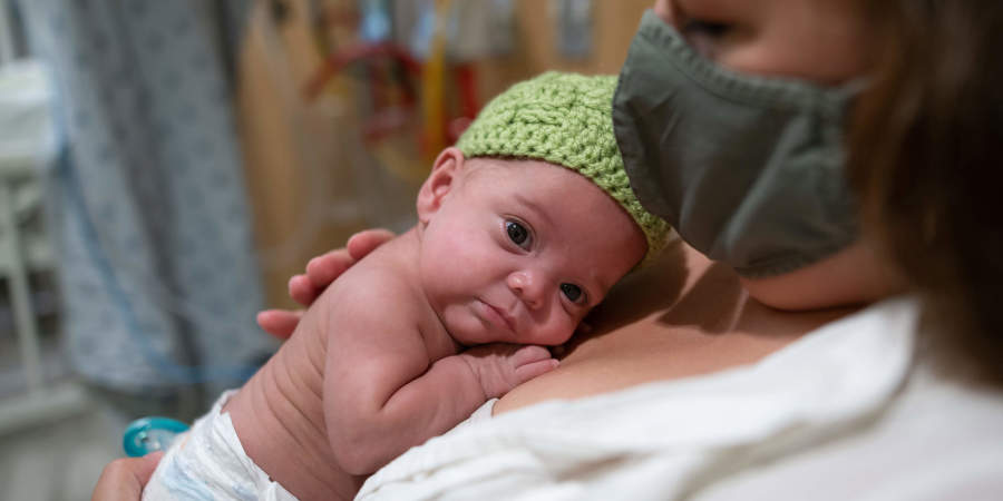 Close up of mom cuddling with baby in the NICU at CHKD.