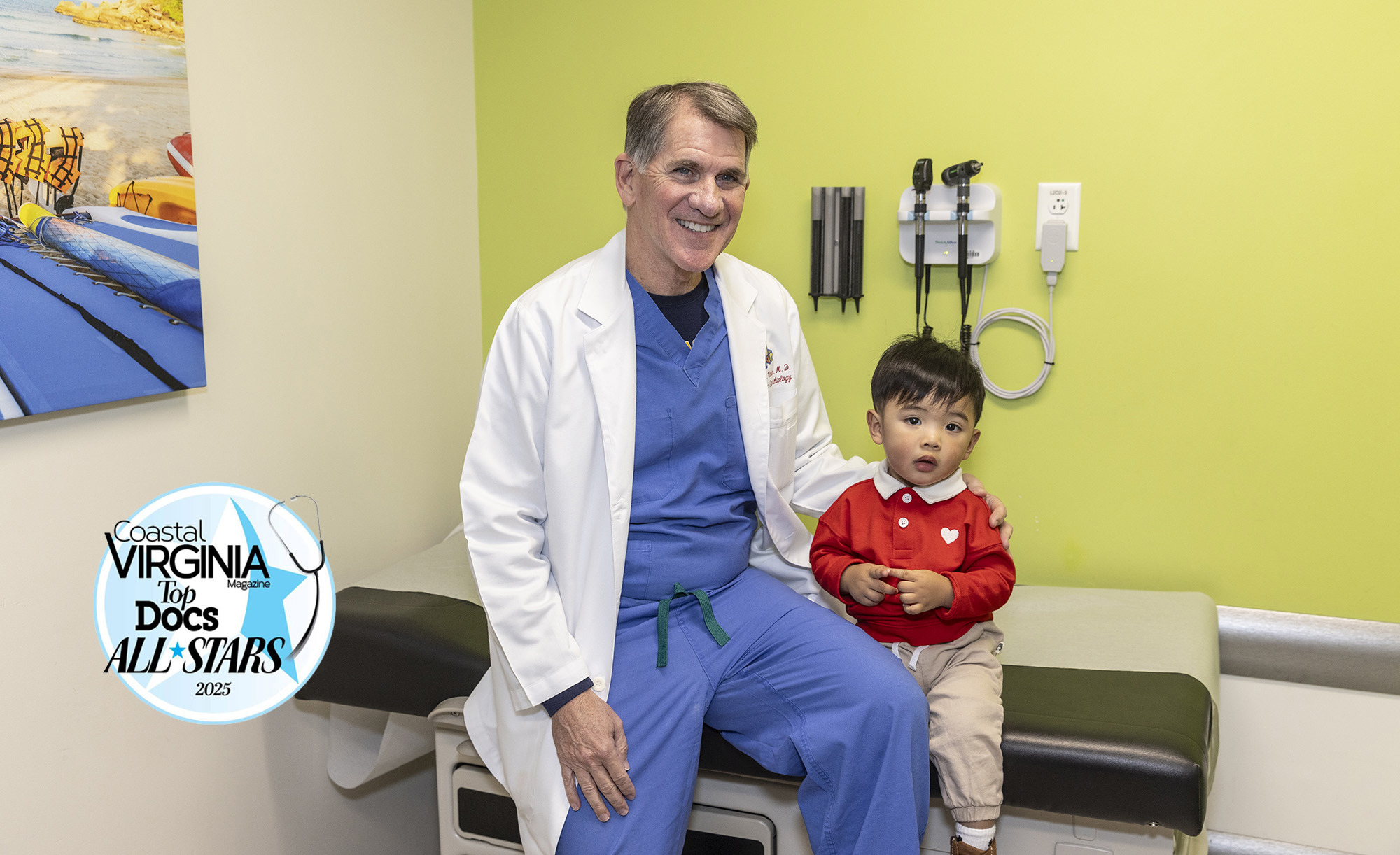 CHKD pediatric cardiologist Dr. Michael Vance smiling with a patient in an exam room.